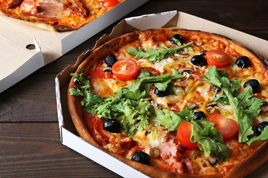Which TV host rewards his staff with pizza?