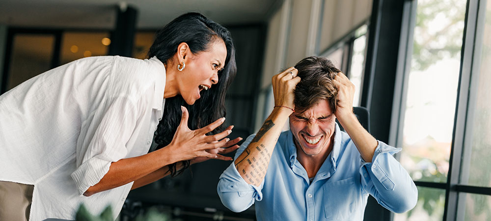 Woman yelling at stressed man