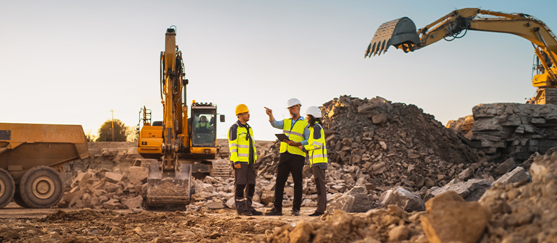 Construction workers discussing site plans