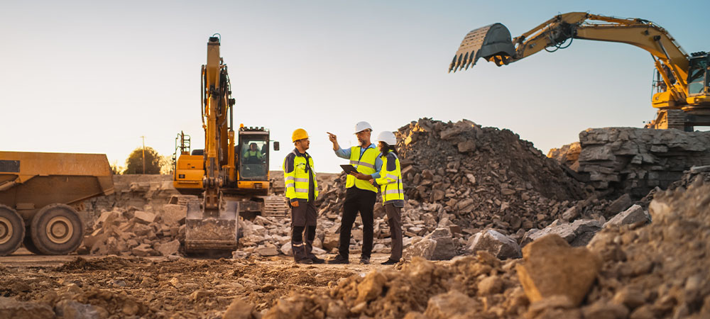 Construction workers discussing site plans