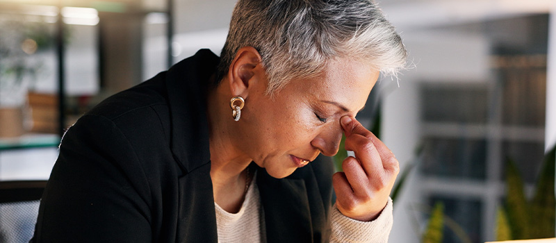 Stressed woman at work desk