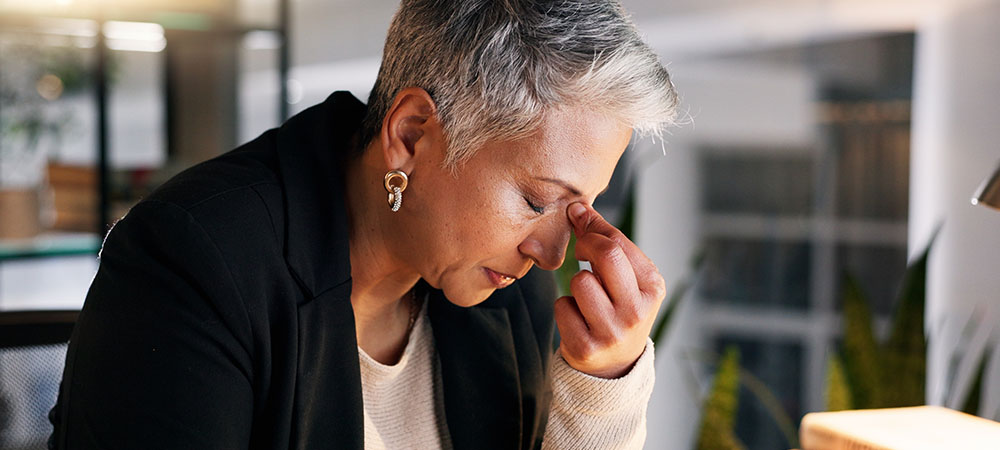 Stressed woman at work desk