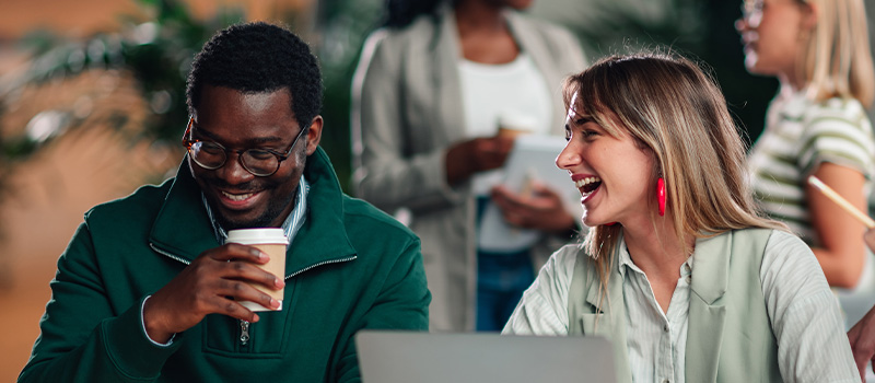 What six CPOs actually say about building a wellbeing culture Smiling coworkers enjoying coffee break