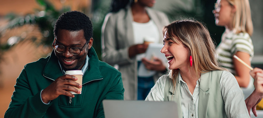 Smiling coworkers enjoying coffee break
