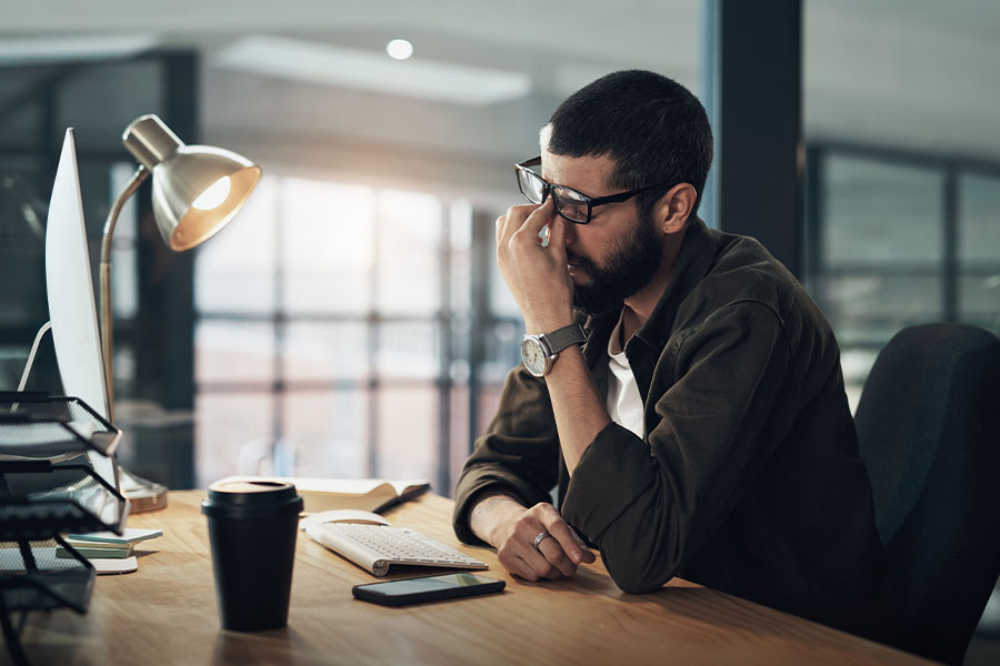 Stressed man working at computer
