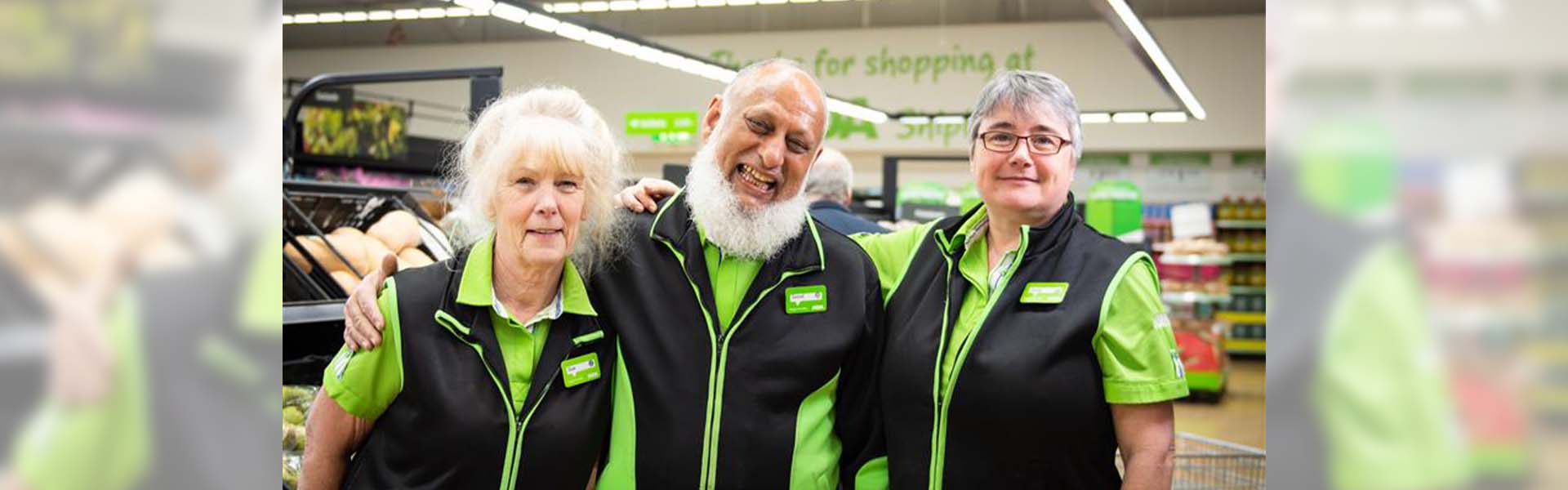Smiling Asda staff posing together