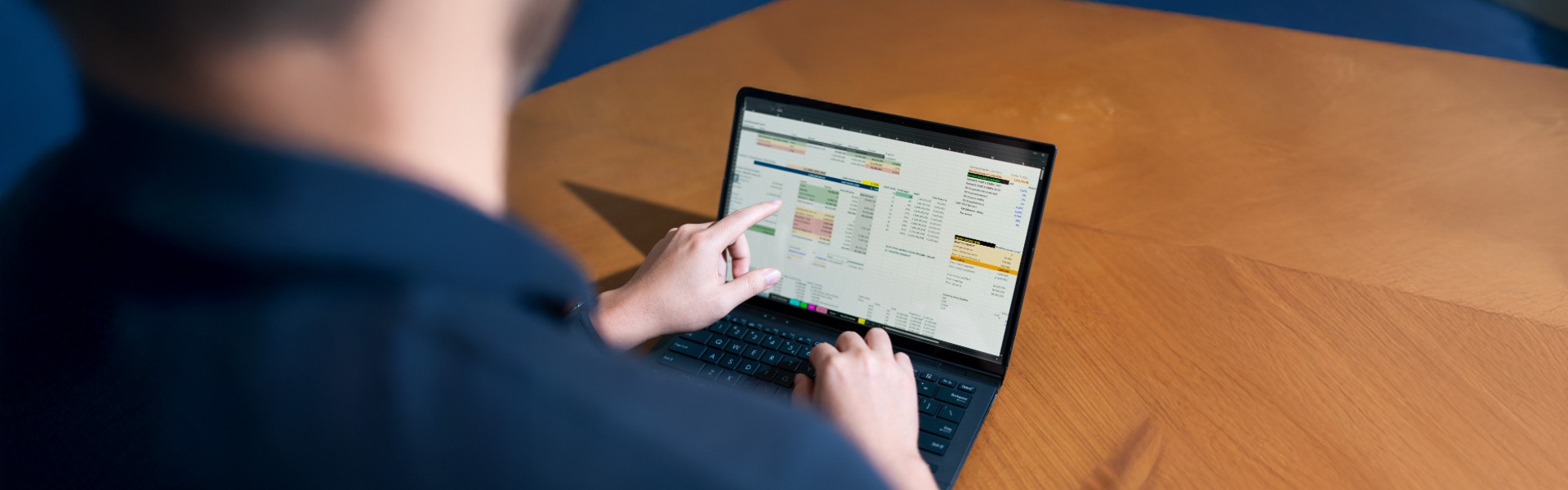 Person analyzing data on laptop