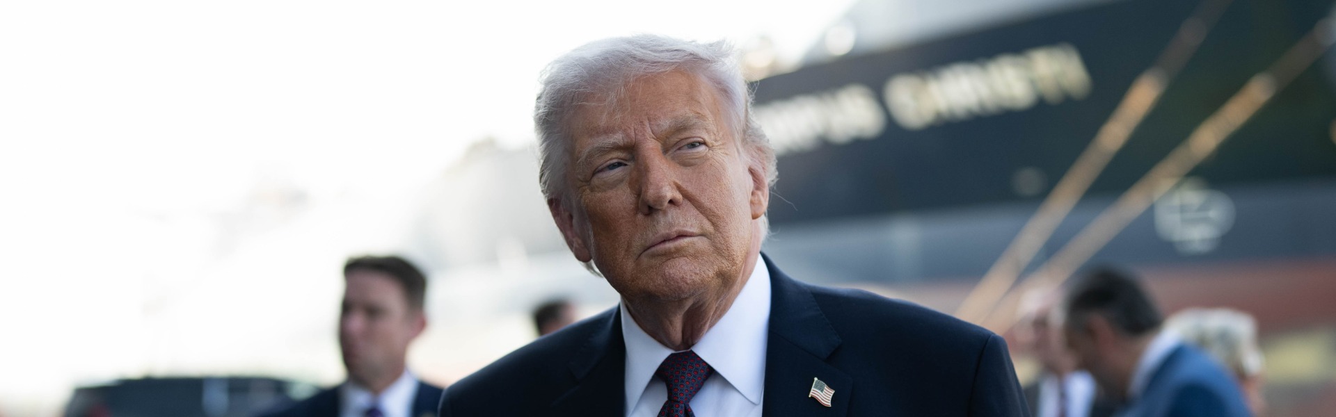 Donald Trump in suit outdoors