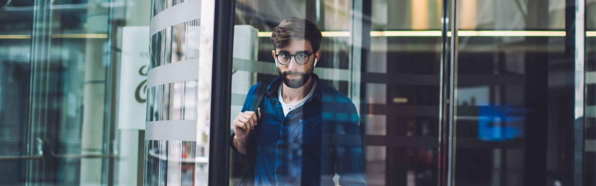 Man exiting modern revolving door