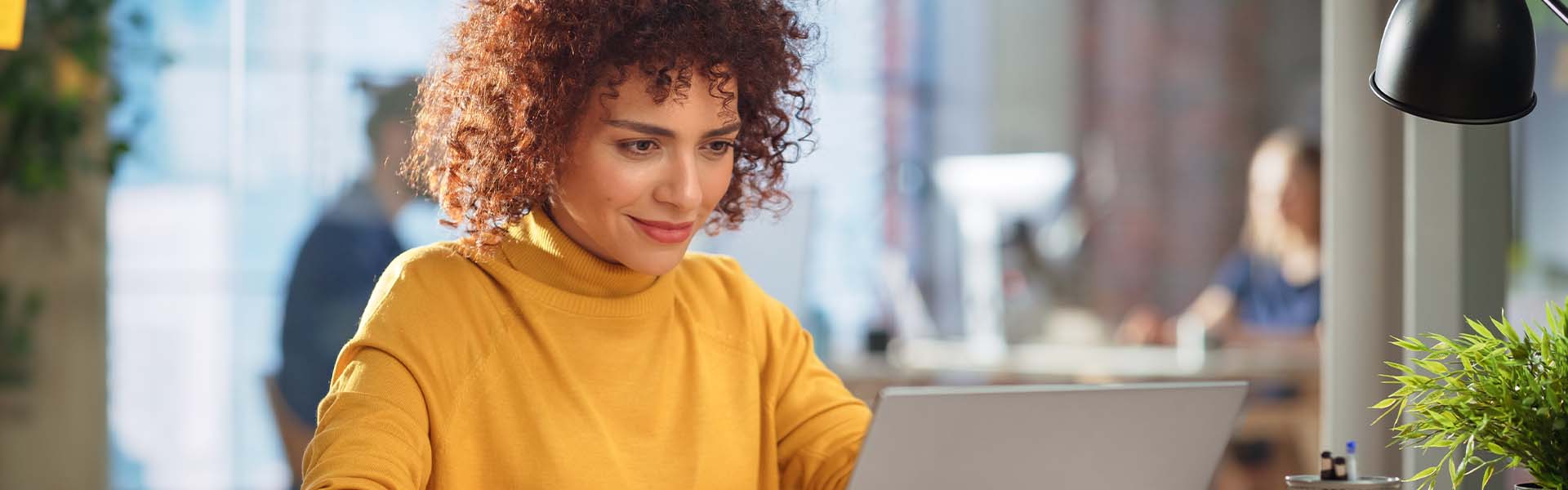 Woman working on laptop smiling