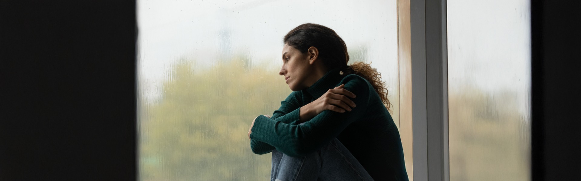 Sad woman looking out window