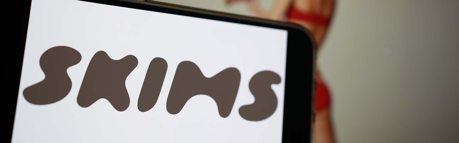 SKIMS logo on smartphone display
