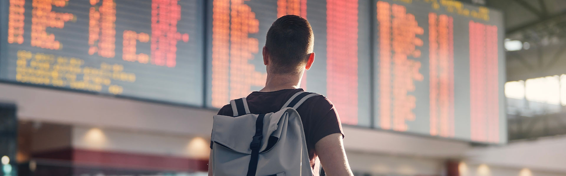 Traveler checking airport departure board