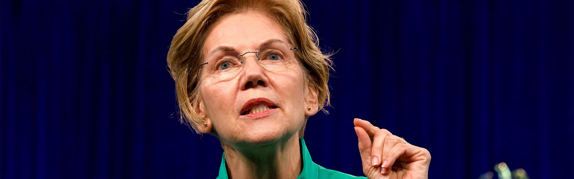 Sen. Elizabeth Warren speaking at podium passionately