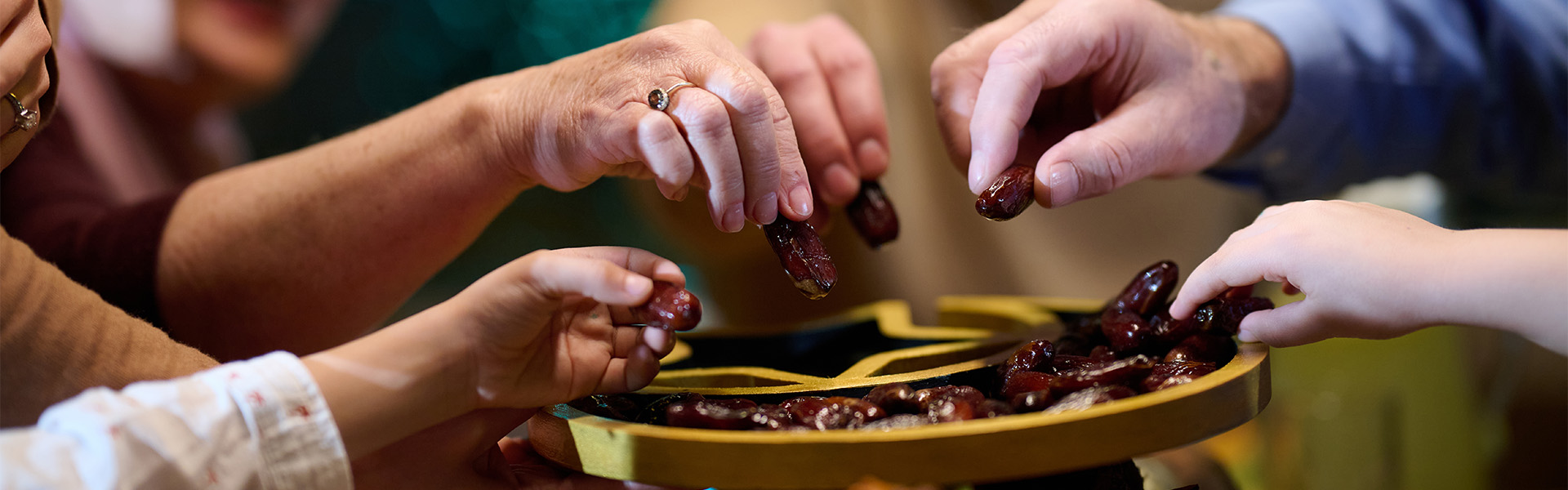 Hands sharing dates during Ramadan