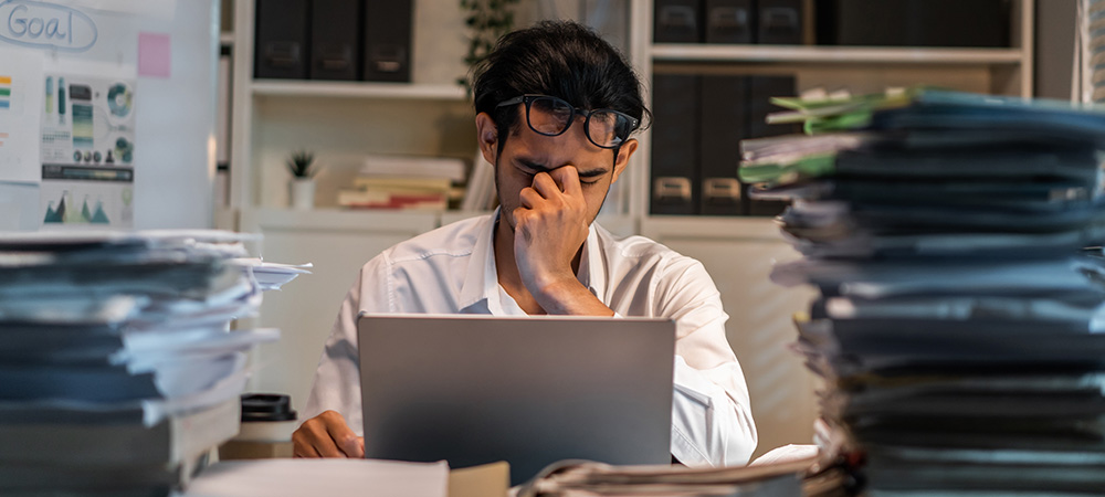 Stressed office worker with paperwork