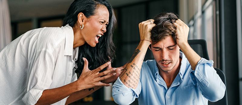 Woman yelling at stressed man