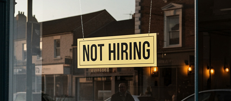 Not hiring sign in window of business