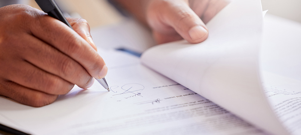 Signing legal document with pen