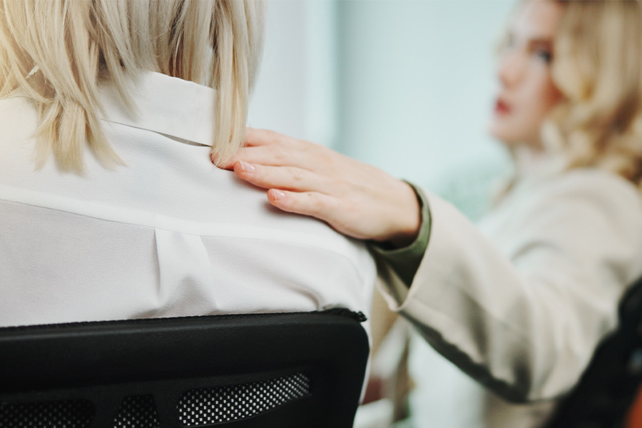Female comforting work colleague