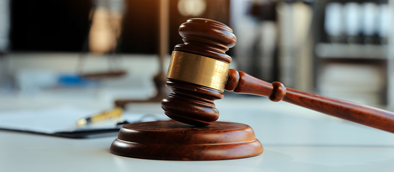 Judge’s gavel on courtroom table