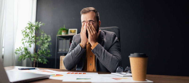 Stressed businessman at office desk