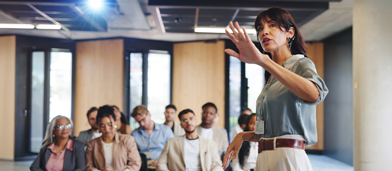 Businesswoman giving presentation to audience