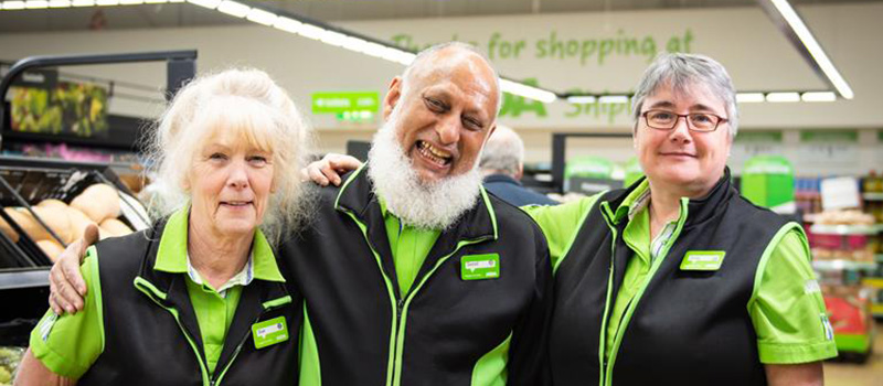Smiling Asda staff posing together