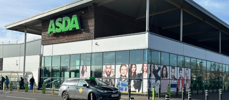 ASDA supermarket exterior with taxi
