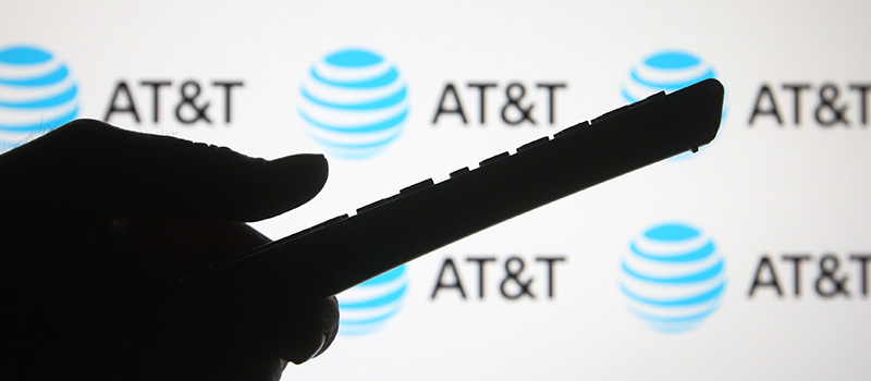Hand holding remote, AT&T logo