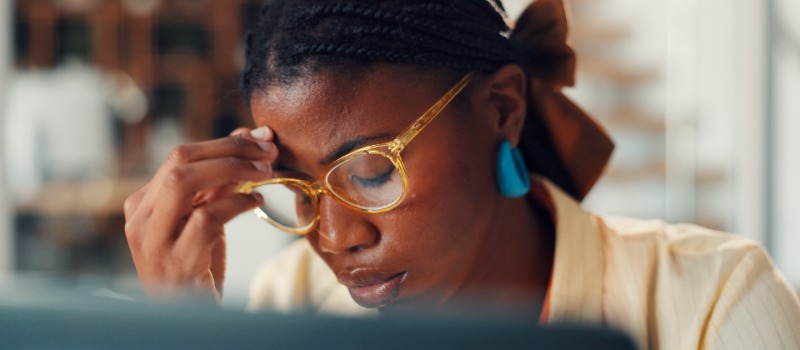 Stressed woman wearing yellow glasses
