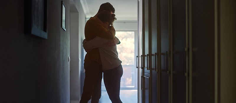 Couple hugging in hallway silhouette