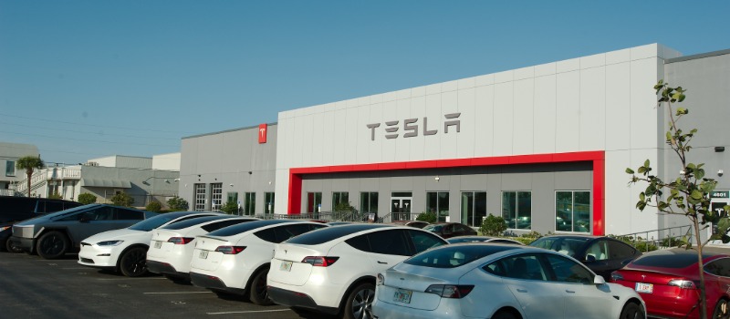 Tesla dealership with parked cars