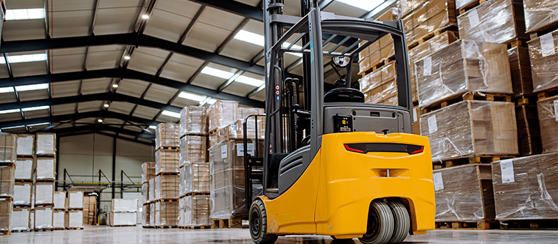 Yellow forklift in warehouse aisle