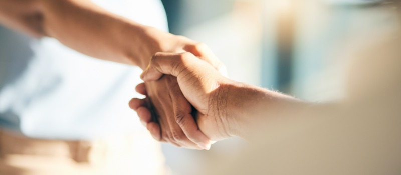 Building the new age of hiring Handshake agreement partnership closeup