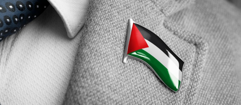 Can employers ban political & religious symbols at work? HR experts weigh in after NHS badge controversy Palestinian flag pin on suit