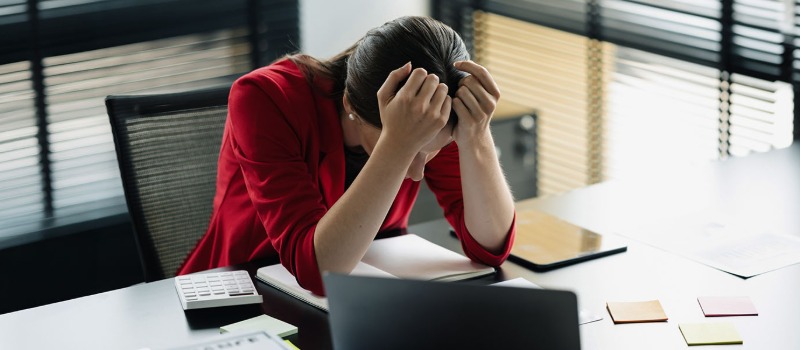 Stressed businesswoman at office desk