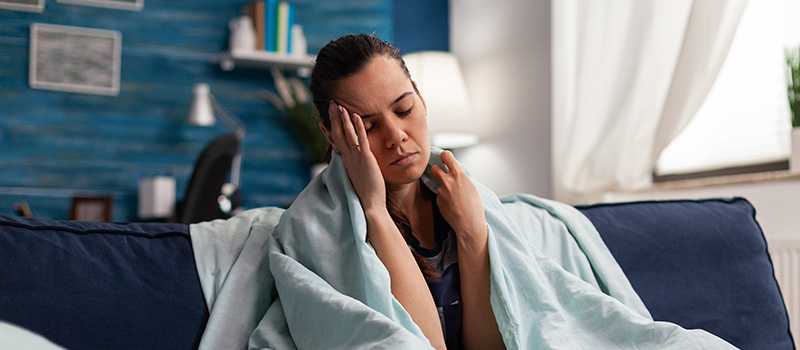 Sick woman resting on couch
