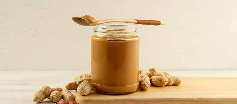 Peanut butter jar with peanuts
