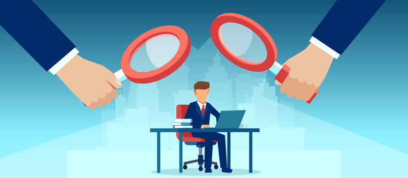 Businessman under scrutiny magnifying glasses