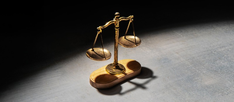 Golden justice scales on table