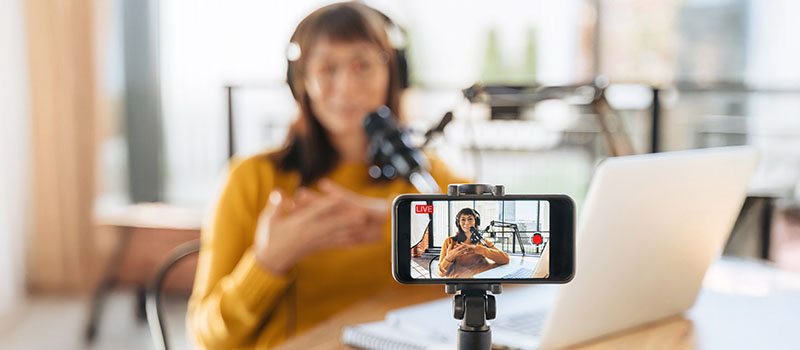 Woman livestreaming podcast at desk