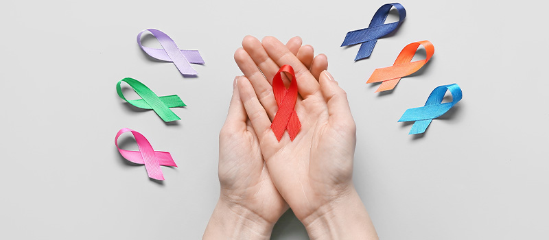 Colorful awareness ribbons in hands