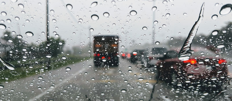 Rainy traffic through car windshield