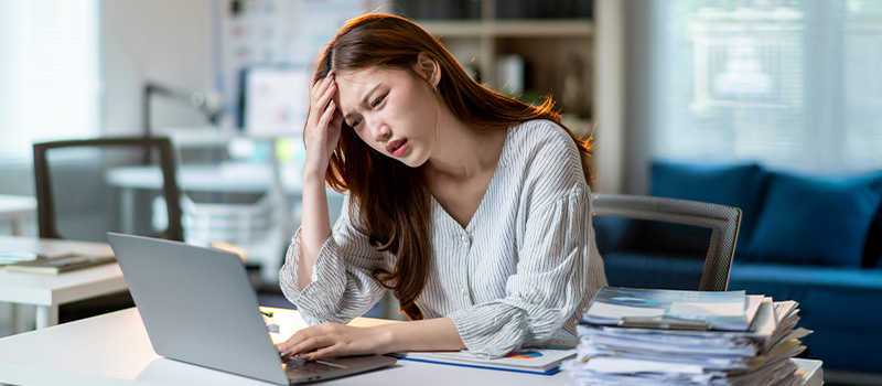 Stressed woman working on laptop