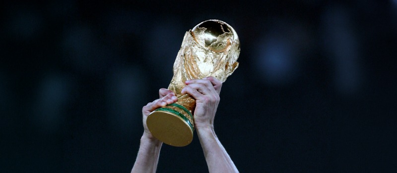 Hands holding World Cup trophy