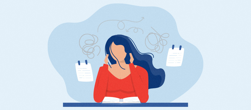 Stressed woman studying at desk