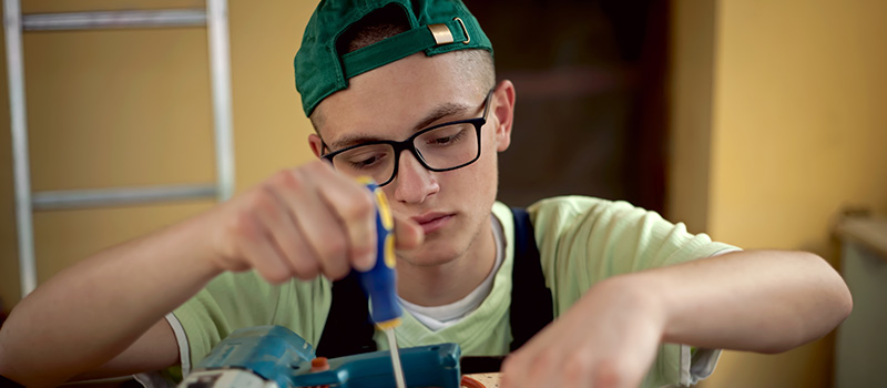 Young man repairing with screwdriver