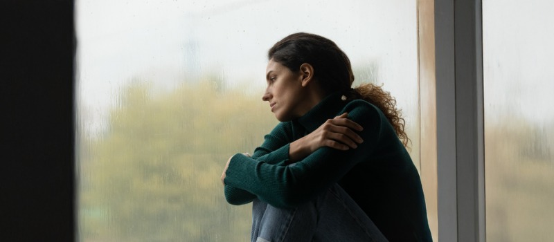Sad woman looking out window