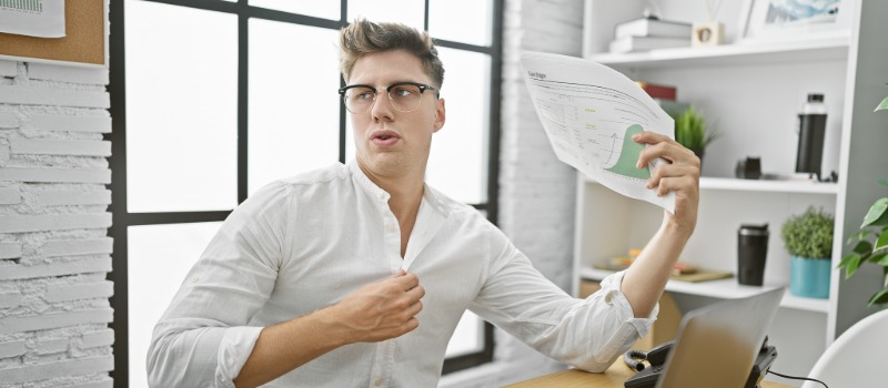 Man feeling hot in office